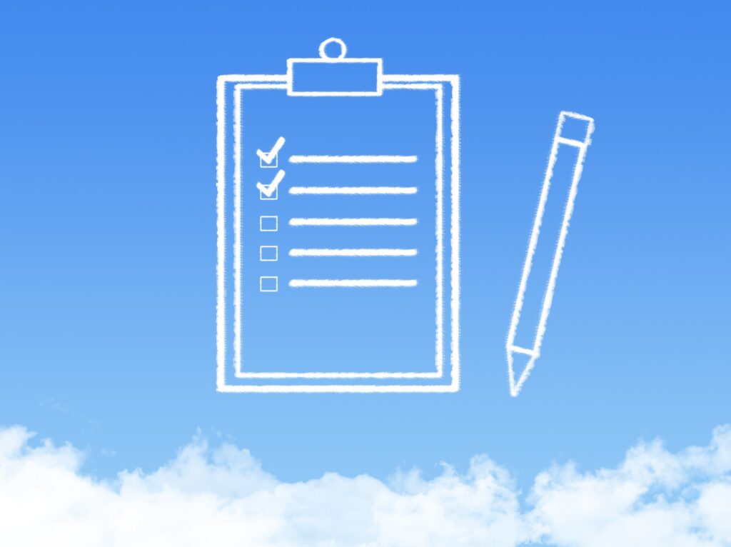 40359926_m-min Pre travel checklist for airport departures, checked off on a clipboard in the sky.